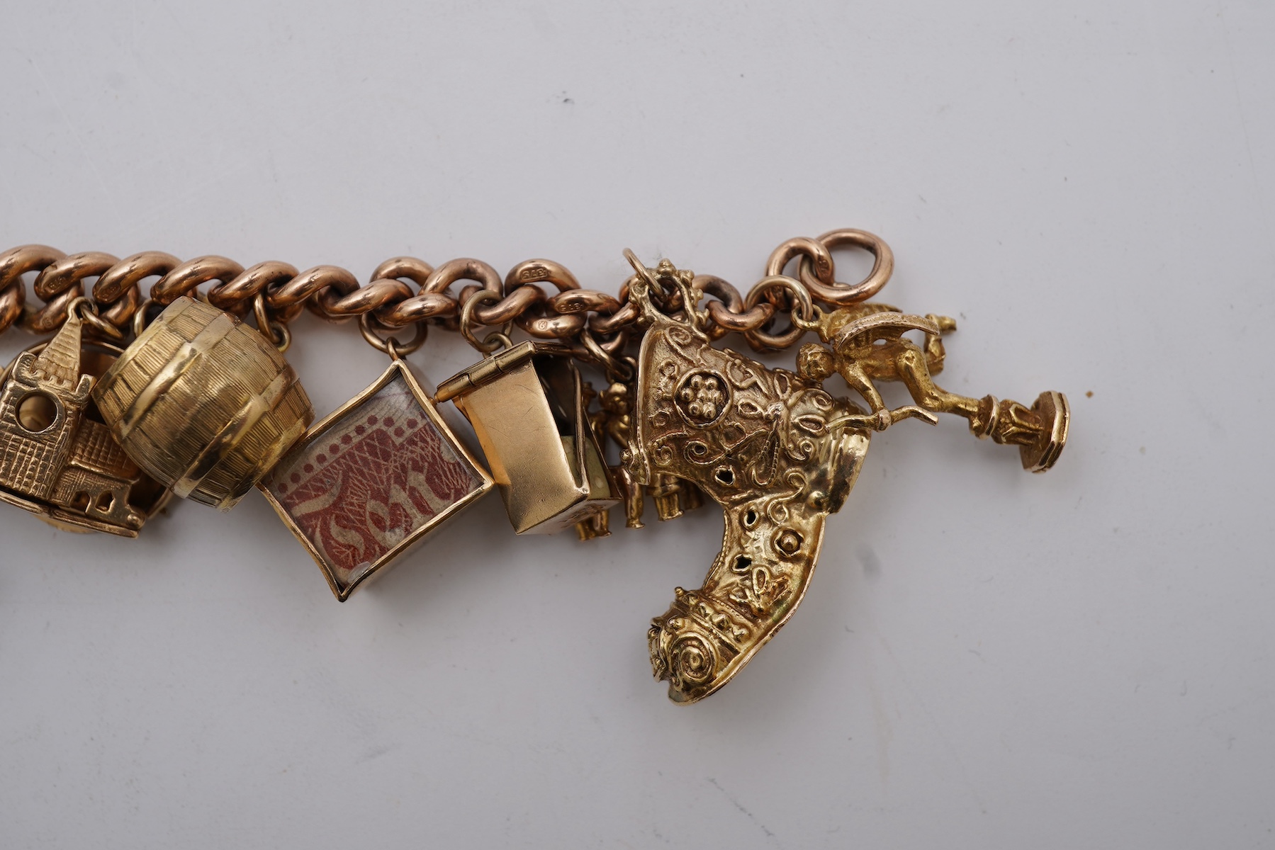 A 9ct gold charm bracelet, mid 20th century